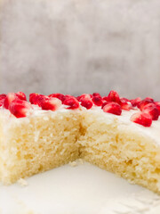 Delicious semolina cake with pomegranate and cream cheese frosting copy space