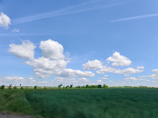 Green field meeting blue sky with white clouds in prague