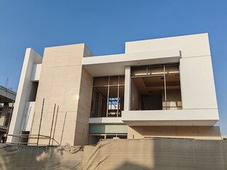 Under Construction luxurious House Or Villa's outdoor view.
Exterior View Of 02 Story Incomplete House With Modern Design.
White Color UnComplete Villa Structure with Erected Scaffolding Pipes around.