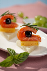 Salmon slices served on toast on pink background