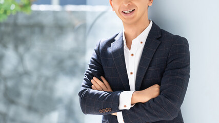 腕組みをする笑顔の男性ビジネスマン