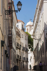 Lonely woman walking at the street in Lisbon city, Portugal