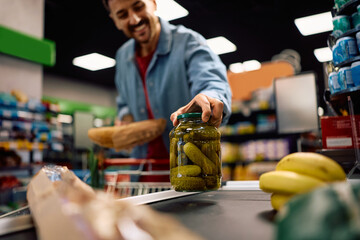 Close up of supermarket customer at the checkout.