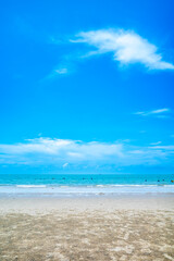 Turquoise sea, white sand beach and sunny day under cloudy clear blue sky, summer in Thailand