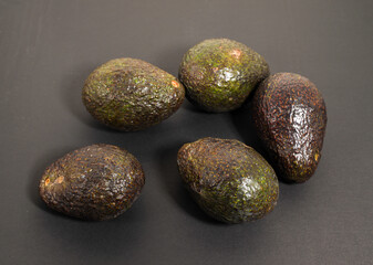 green avocado with black background