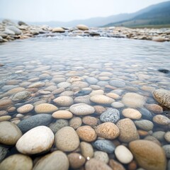 A gentle stream flowing over smooth pebbles, water sparkling under morning light. A serene view of smooth, colorful pebbles submerged in clear water, creating a tranquil landscape reflecting nature's 