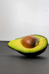 half avocado with black background