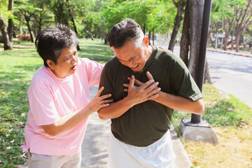 Wife scary concerned about her husband sudden heart attack and experiencing symptoms fatigue shortness breath exhaustion chest tightness and excessive sweating due strenuous exercise outdoors in hot.