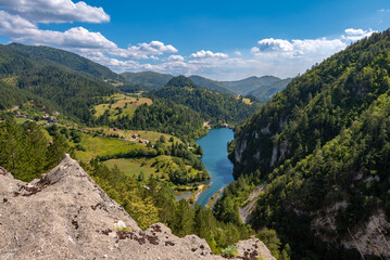 View of the mountain lake and wooded slopes