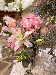 Vibrant floral arrangement in a luxurious hotel lobby during a sunny afternoon