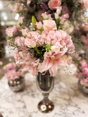Beautiful floral arrangement with pink flowers displayed in elegant vase at a boutique