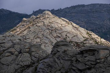 Layered Mountains and rocks illuminated by the sun, beautiful wild natural background in the Koktau mountain range
