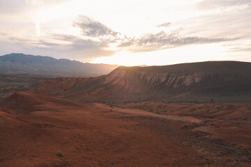 Epic sunset over the red mountains of Bogutty add colour to the wild desert landscape