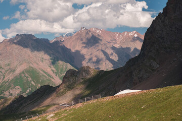 A beautiful mountain landscape of the peaks of the Zailiysky Alatau opens up from the popular tourist Talgar Pass in the city of Almaty