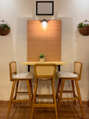 Portrait of a cozy corner of dining table set with rattan chairs, a typical contemporary tropical resort style. Suitable for cafe or restaurant, or a villa for holiday retreat. interior design