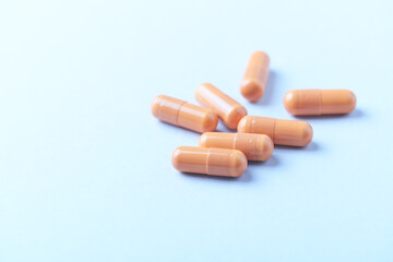 Calcium carbonate capsules. Bright paper background. Soft focus. Close up. Copy space