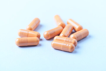 Calcium carbonate capsules. Bright paper background. Soft focus. Close up. Copy space.