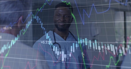 Reviewing doctor in scrubs with stethoscope examining charts in clinic, with candlestick graph