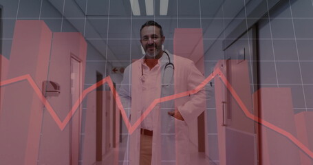 Standing doctor wearing coat, scrubs, stethoscope in hospital corridor, with red line graph overlay