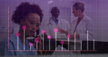Speaking nurse in scrubs using telephone handset at reception desk, data overlay, copy space