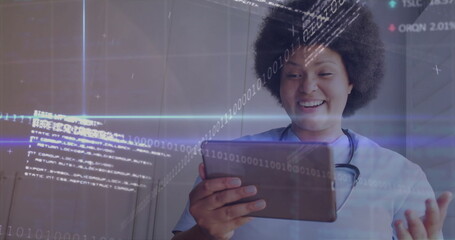 Smiling nurse wearing scrubs using tablet in clinic hallway, with stethoscope, data, copy space