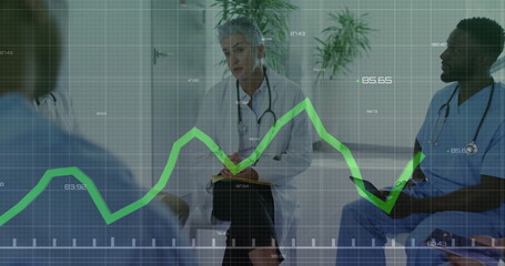 Consulting team with senior physician in coat in clinic with stethoscopes, digital graph overlay