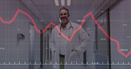 Standing doctor wearing white lab coat and stethoscope in hospital corridor, with red chart overlay