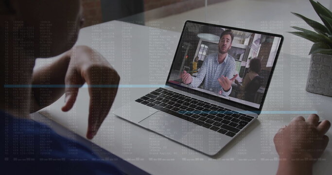 Viewing meeting on laptop screen at home office desk, with succulent, desk divider and code overlay