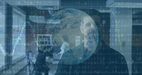 Standing bearded man analyzing globe and binary code in office, consulting colleagues at monitors