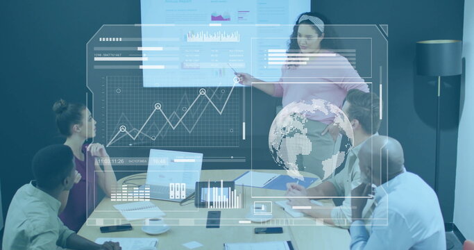Pointing presenter in pink blouse showing rising graph at office with laptops, overlays, copy space