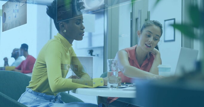 Pointing laptop screen coworkers discussing project in open-plan office with digital overlays