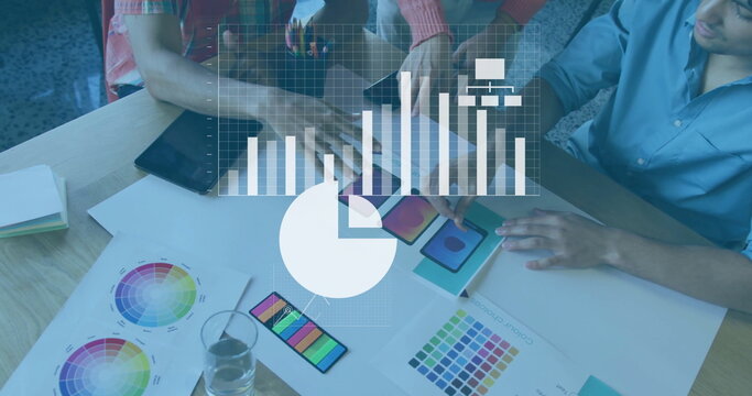 Leaning designers studying color charts and swatches in studio, with digital devices and overlays - Powered by Adobe