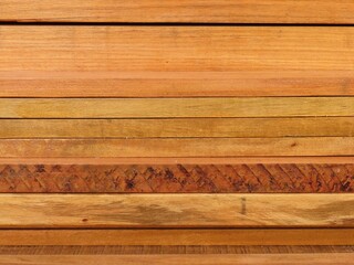 Varnished peroba planks stack. Stack of varnished peroba lumber. Wooden texture background.