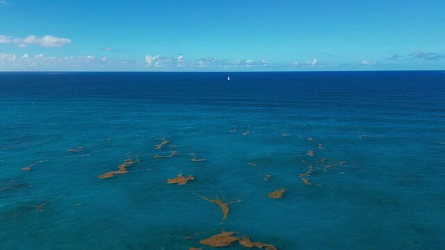 Turquoise Caribbean Sea and a Sailing Ship in the Distance. Aerial view