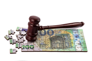 Judge's gavel and 100 euro note made from puzzle pieces