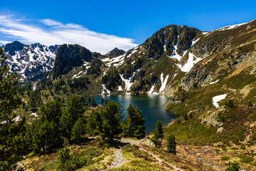 Blue Lake at the foot of Sarrat de Gabensa and Roc de Bragues in spring, with the last snow