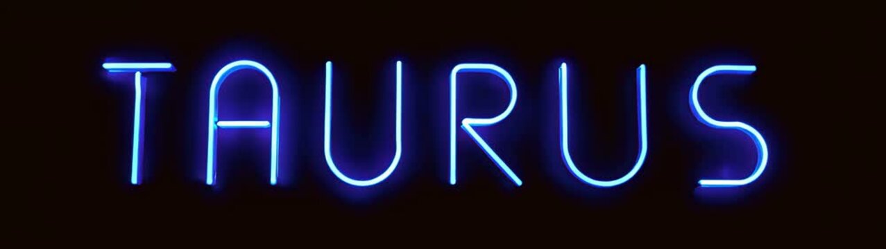 A close up of a neon sign that says taurus