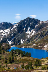 View of Black Lake from the Col de la Coumeille de l’Ours in spring with snow on the peaks