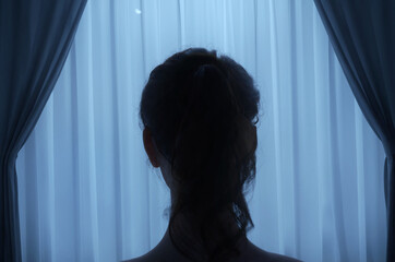 back of woman's head behind sheer curtains at night. 3D Rendering