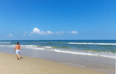 Persona che passeggia sulla Spiaggia del mare in estate