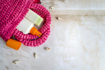 Sunscreen stick and spf cream in a straw bag . Sun Protection Face Cream