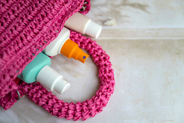 Sunscreen stick cream and after sun lotion  in a straw bag . Sun Protection Face Cream