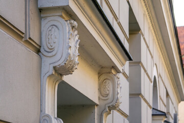 Architectural detail showing decorative corbels under the cornice on a bright, renovated...
