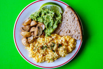 Scambled Eggs With Mashed Avacado Fried Musherooms and Seeded Bread