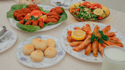 Traditional Turkish appetizers and salads served on elegant plates with a glass of ayran