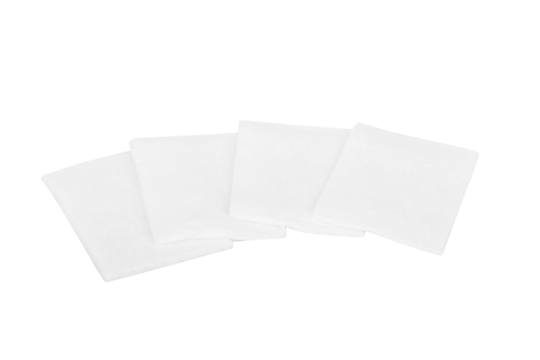 Four square white cotton pads isolated on white background