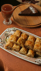 Turkish baklava and chocolate tart served with a glass of traditional sherbet drink