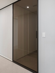The middle door was made of slightly dark glass to avoid creating a clutter-free space