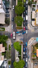 Urban intersection from above with afternoon city traffic.