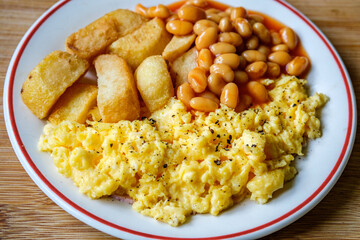 Scrambles Eggs With Baked Beans In Tomato Sauce And Thick Cut Fried Chips